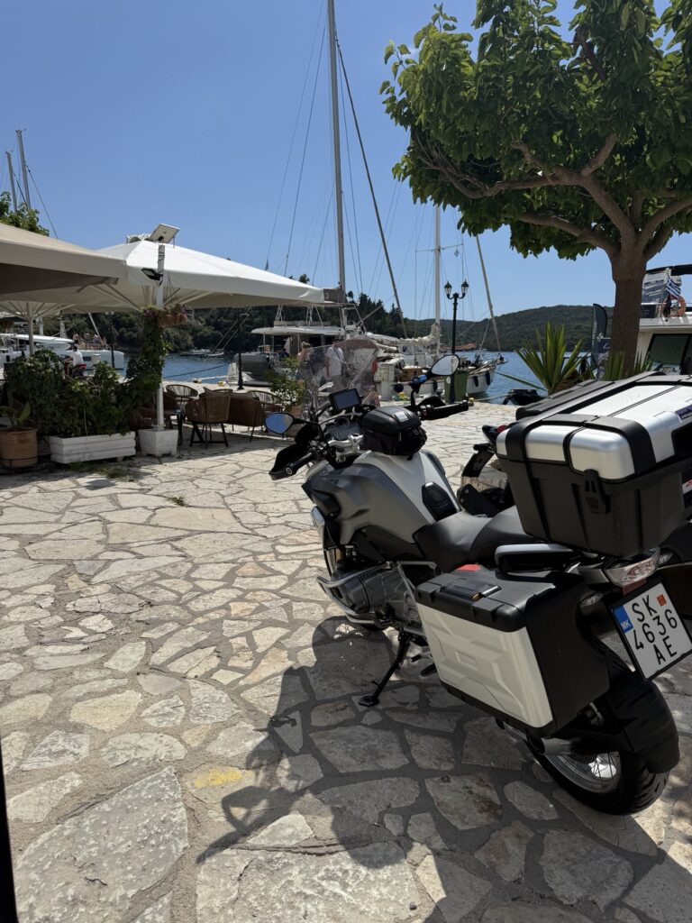 Motorcycle overlooking the harbour in Sivota on a Northern Greece road trip